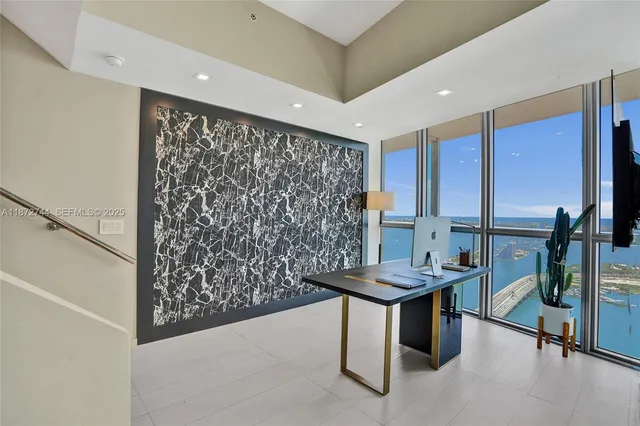 a living room with furniture and large windows