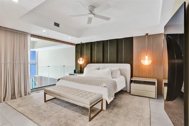 a bedroom with a large bed and a large window