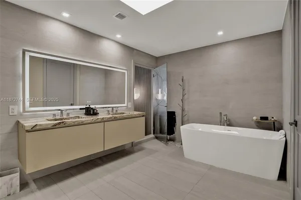 a bathroom with double vanity and a shower