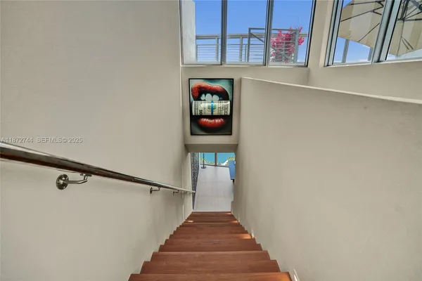 a patio with a table and chairs under an umbrella