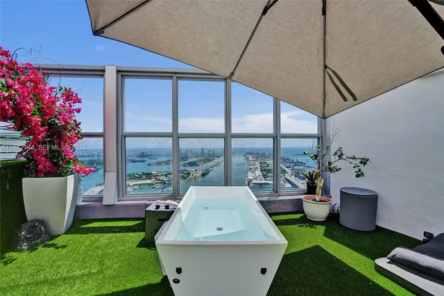 a large bedroom with a bed and large window