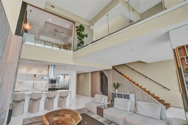 a kitchen with stainless steel appliances a dining table and chairs