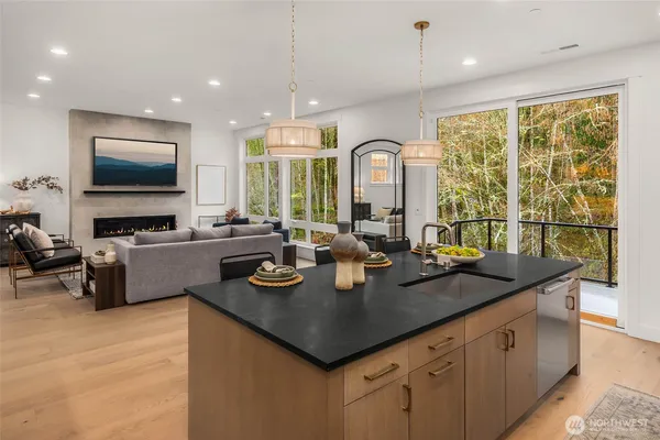 a kitchen with sink a counter top space and living room view
