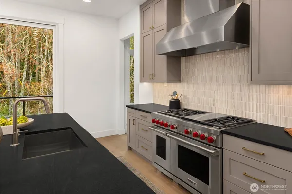 a stove top oven sitting inside of a kitchen