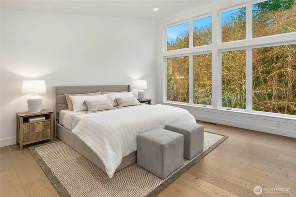 a bedroom with a large bed and a large window