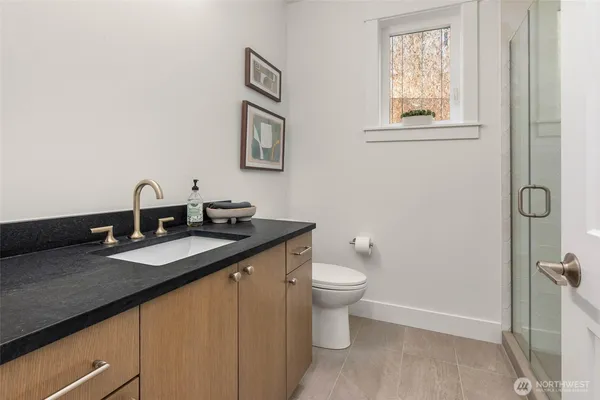 a view of an empty room with cabinet and door