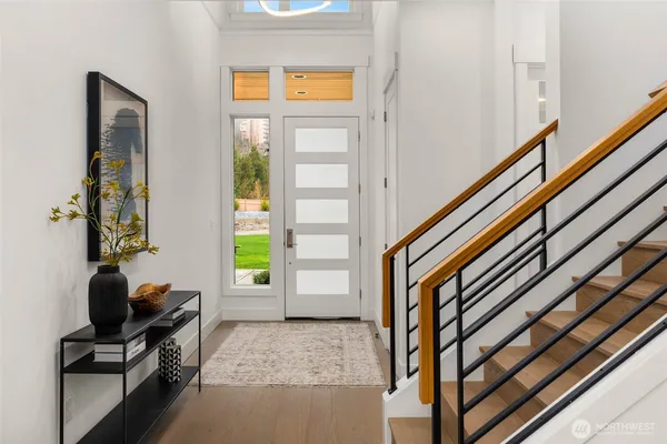 a view of an entryway with wooden floor