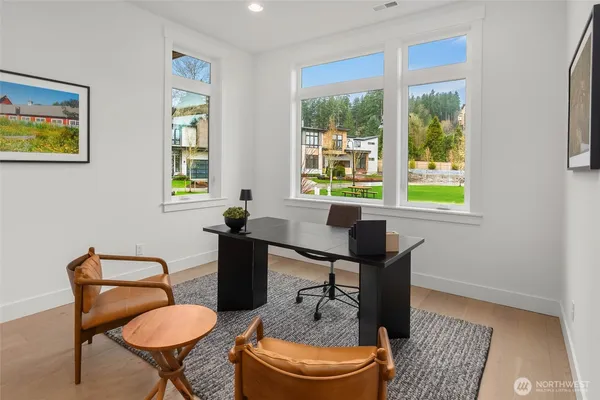 a view of a workspace with furniture and a window