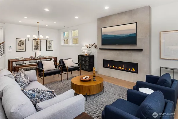 a living room with furniture a flat screen tv and a fireplace