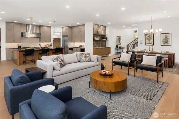 a living room with furniture kitchen view and a table