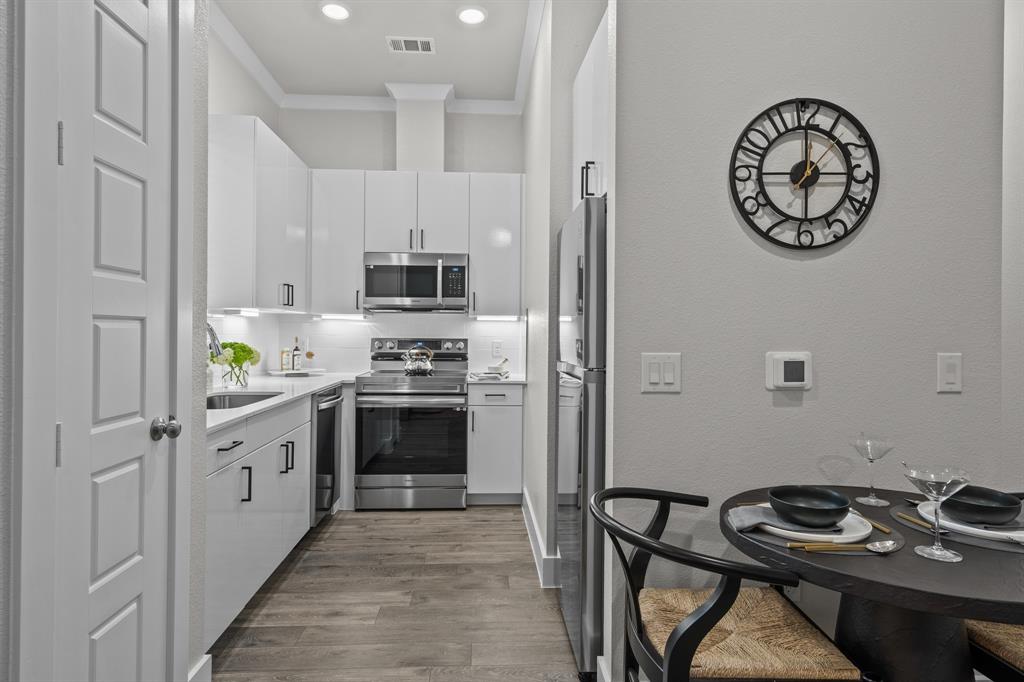 3272 Ganzer Road West, Unit 415B Denton, TX 76207 - Photo 4 of 25 a kitchen with a stove a refrigerator and a sink
