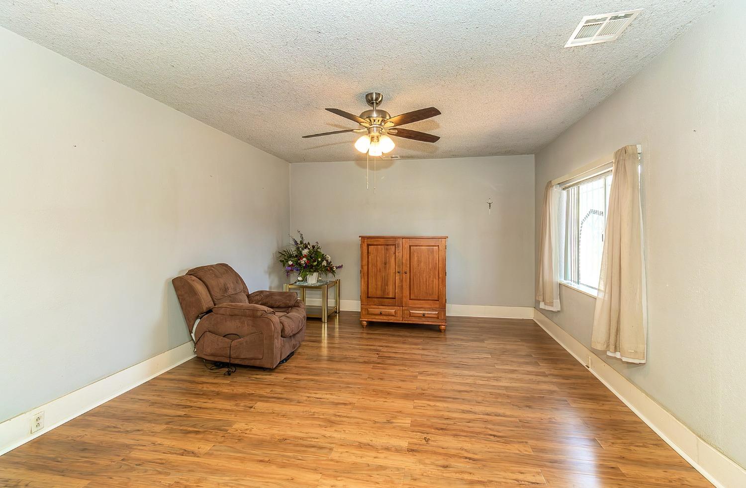 37991 Pound Road Dinuba, CA 93618 - Photo 15 of 32 a living room with furniture and a chandelier