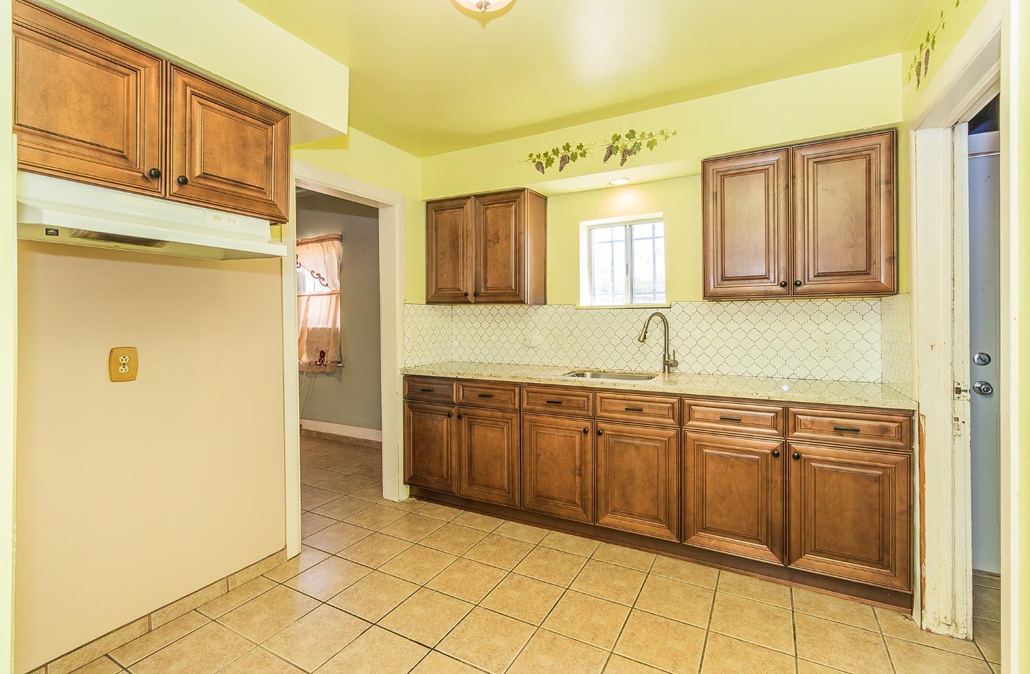37991 Pound Road Dinuba, CA 93618 - Photo 19 of 32 a kitchen with granite countertop a sink and cabinets