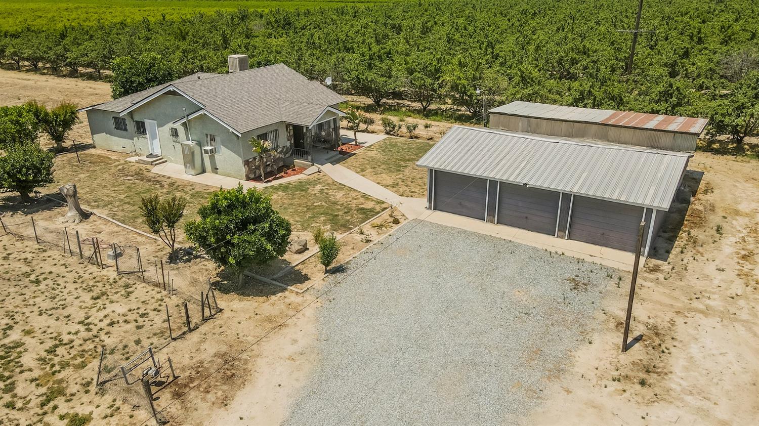 37991 Pound Road Dinuba, CA 93618 - Photo 2 of 32 a view of a house with a yard and wooden fence