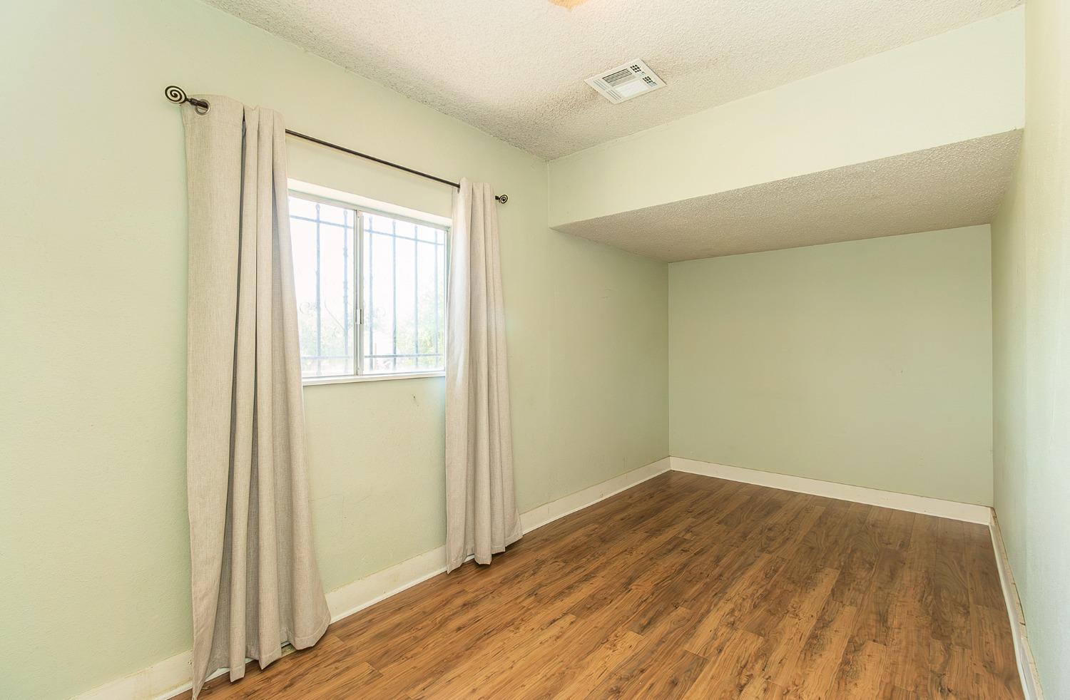 37991 Pound Road Dinuba, CA 93618 - Photo 24 of 32 a view of a room with wooden floor and a window