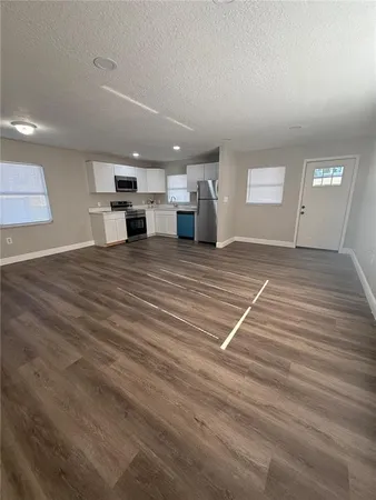 a view of a room with wooden floor and stairs