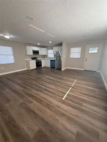 a view of a room with wooden floor and stairs