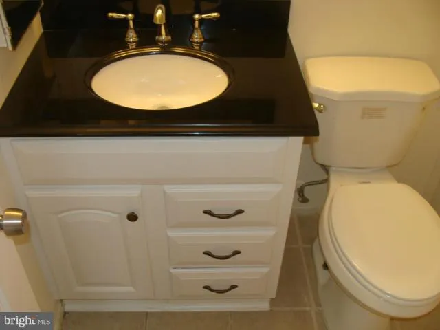 a bathroom with a toilet and a mirror