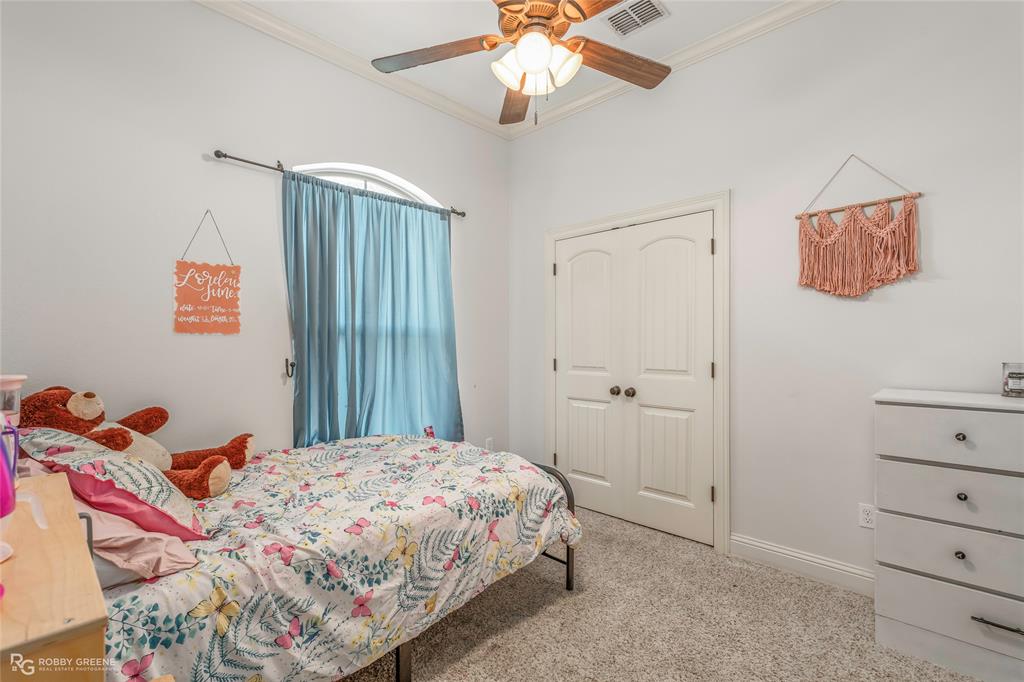 711 Reeds Reef Bossier City, LA 71112 - Photo 24 of 36 a bedroom with a bed and a chandelier