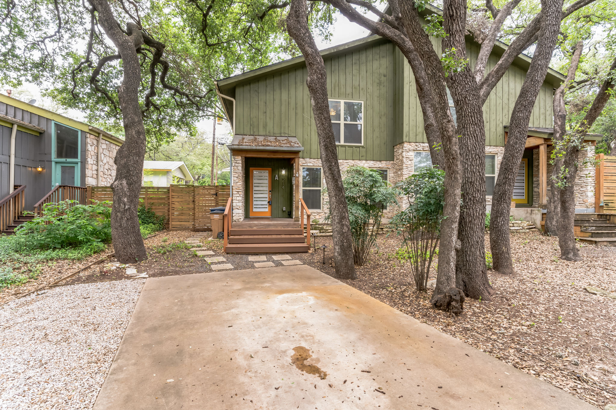 3214 Clawson Road, Unit A Austin, TX 78704 - Photo 26 of 26 Mature trees frame the appealing green and stone facade of this inviting residence.