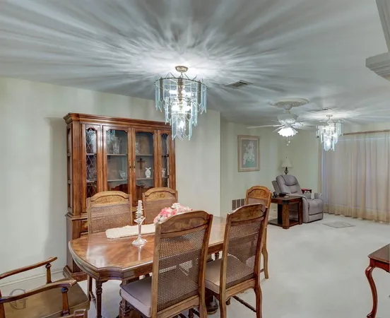 a dining room with furniture and chandelier