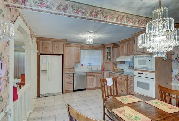 a kitchen with refrigerator and cabinets