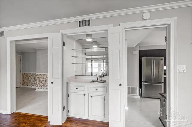a view of a hallway with wooden shelves