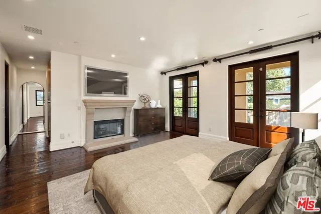 a spacious bedroom with a large bed and a fireplace