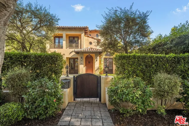 a front view of a house with trees