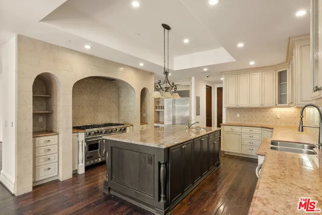 a kitchen with stainless steel appliances granite countertop a stove and a refrigerator