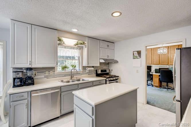 418 Park Ridge Road Albemarle, NC 28001 - Photo 11 of 28 a kitchen with stainless steel appliances a sink a stove a refrigerator and cabinets