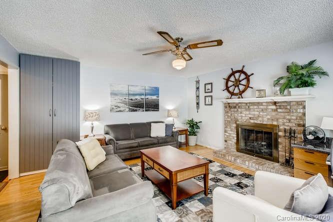 418 Park Ridge Road Albemarle, NC 28001 - Photo 13 of 28 a living room with furniture a fireplace and a flat screen tv
