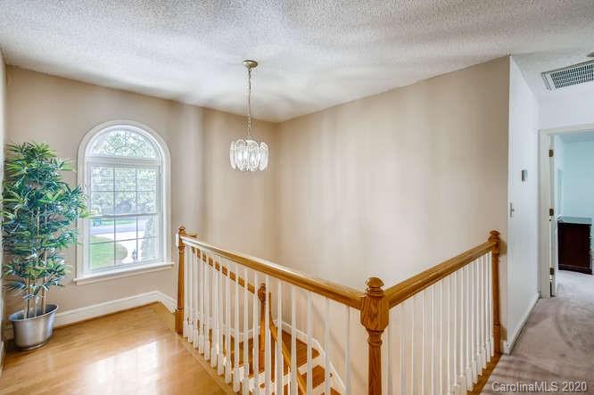 418 Park Ridge Road Albemarle, NC 28001 - Photo 16 of 28 a view of a hallway with a window and wooden floor