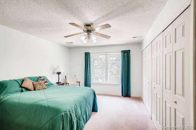 418 Park Ridge Road Albemarle, NC 28001 - Photo 17 of 28 a bedroom with a large bed and a chandelier