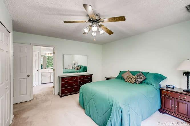 418 Park Ridge Road Albemarle, NC 28001 - Photo 18 of 28 a bedroom with a bed and a chandelier