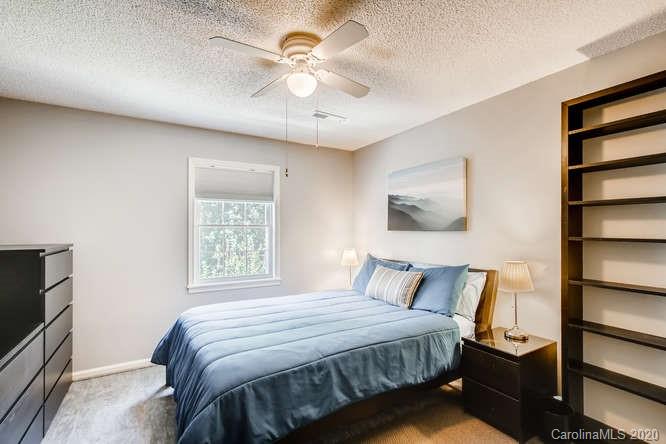 418 Park Ridge Road Albemarle, NC 28001 - Photo 22 of 28 a bedroom with a bed and a flat screen tv