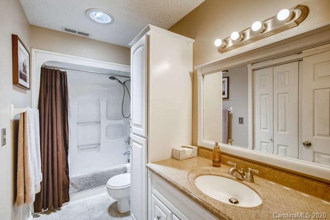418 Park Ridge Road Albemarle, NC 28001 - Photo 24 of 28 a bathroom with a granite countertop sink toilet and shower