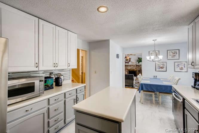 418 Park Ridge Road Albemarle, NC 28001 - Photo 8 of 28 a kitchen with cabinets and wooden floor