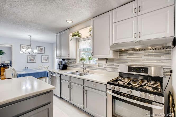 418 Park Ridge Road Albemarle, NC 28001 - Photo 9 of 28 a kitchen with white cabinets and appliances
