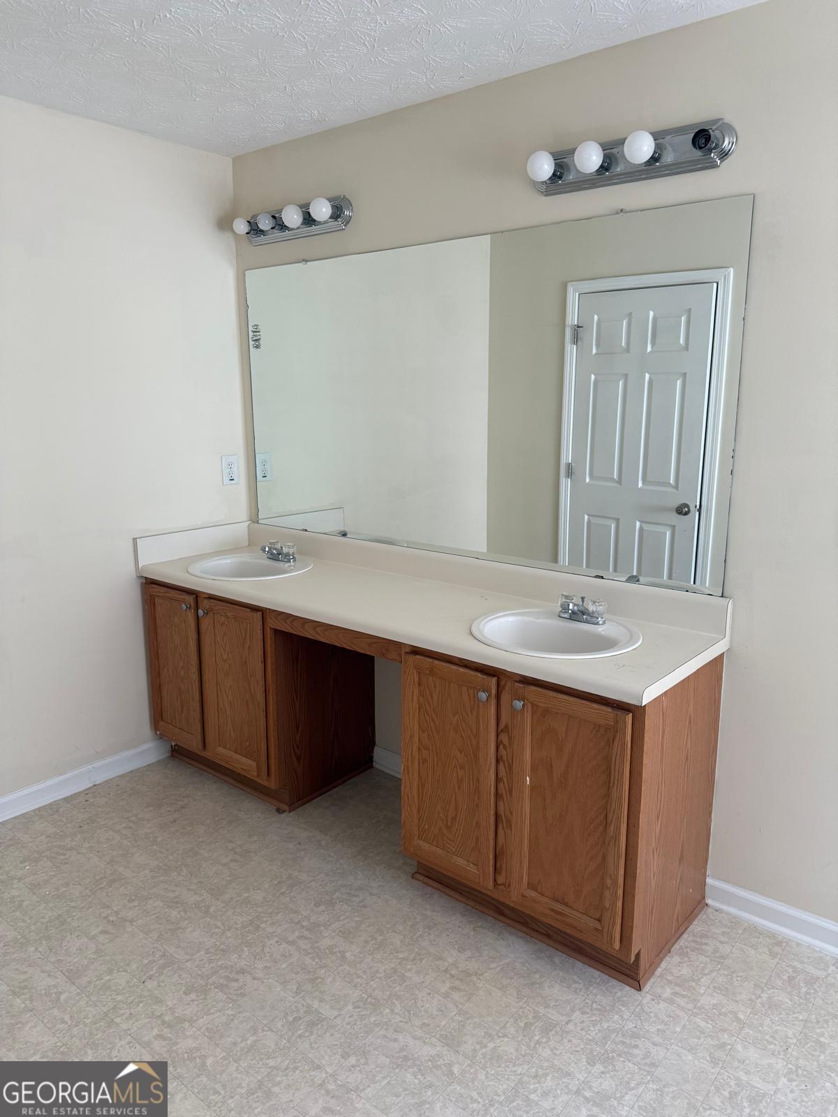 2909 Rusticwood Drive Southwest Snellville, GA 30078 - Photo 16 of 17 a bathroom with a sink double vanity and a mirror
