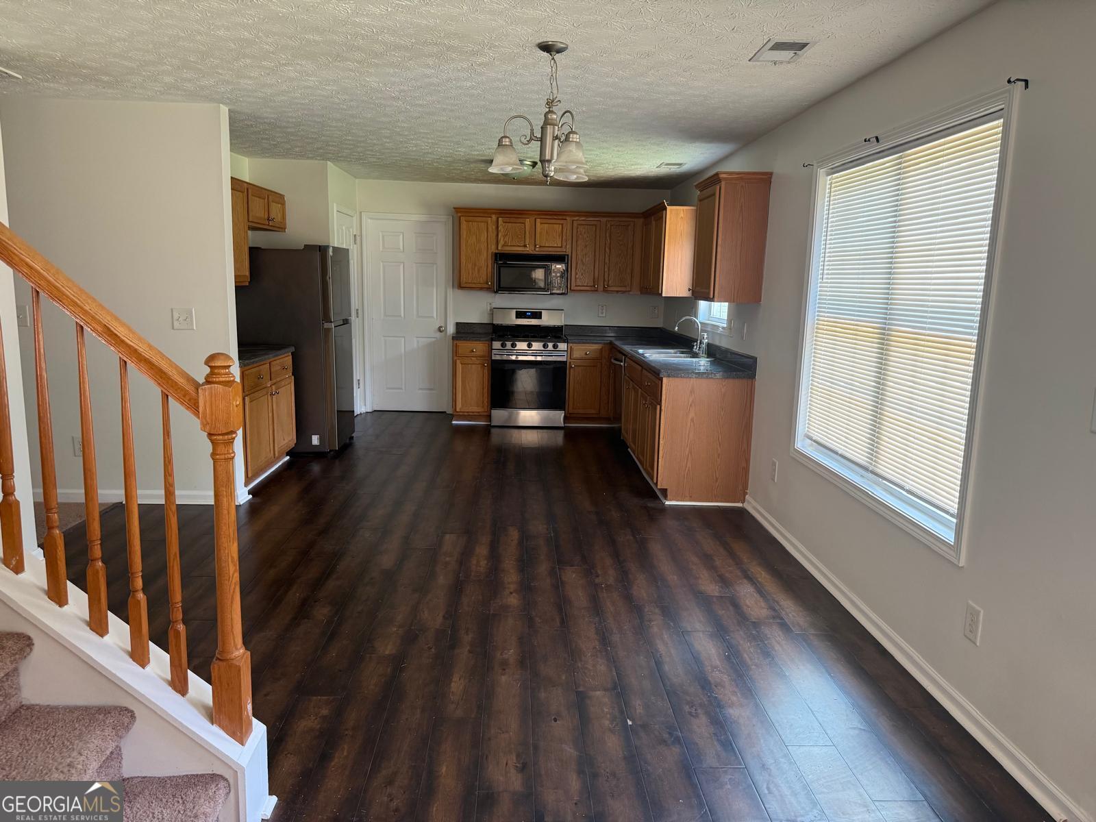 2909 Rusticwood Drive Southwest Snellville, GA 30078 - Photo 3 of 17 a kitchen with wooden floors and appliances