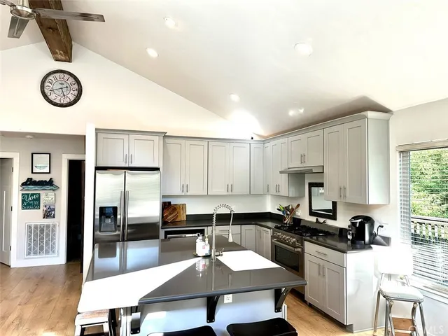 a large kitchen with a table chairs and a refrigerator