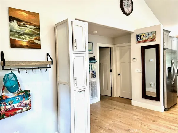 a view of kitchen with refrigerator stove and wooden floor
