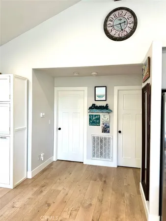 a view of an entryway with wooden floor