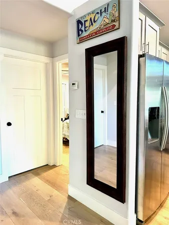 a view of a hallway with a kitchen