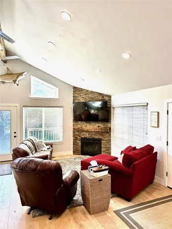 a living room with furniture flat screen tv and a fireplace
