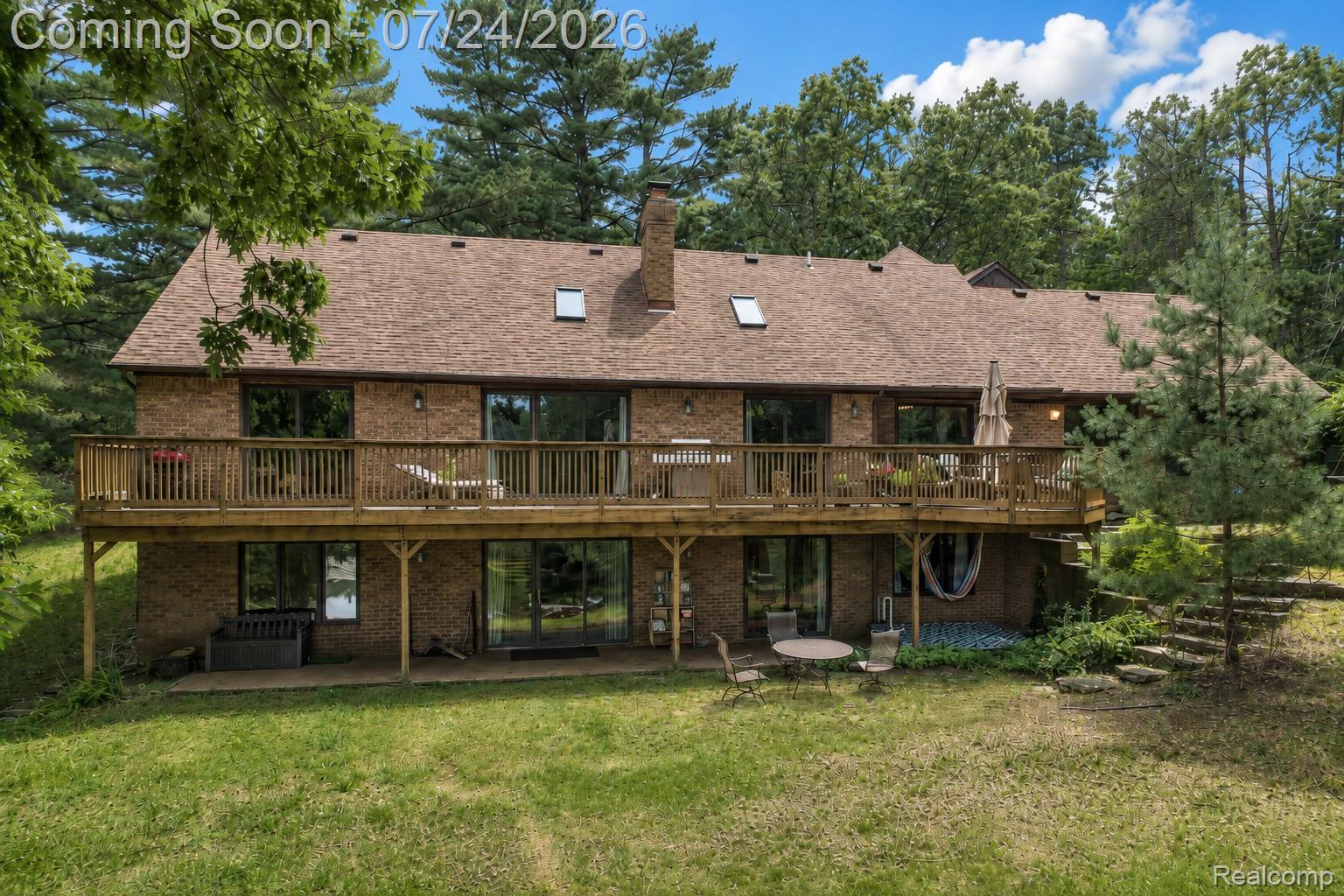 377 Ridgemont Road Oxford, MI 48370 - Photo 46 of 52 Brick exterior with a multi-level wood deck and a lower-level patio