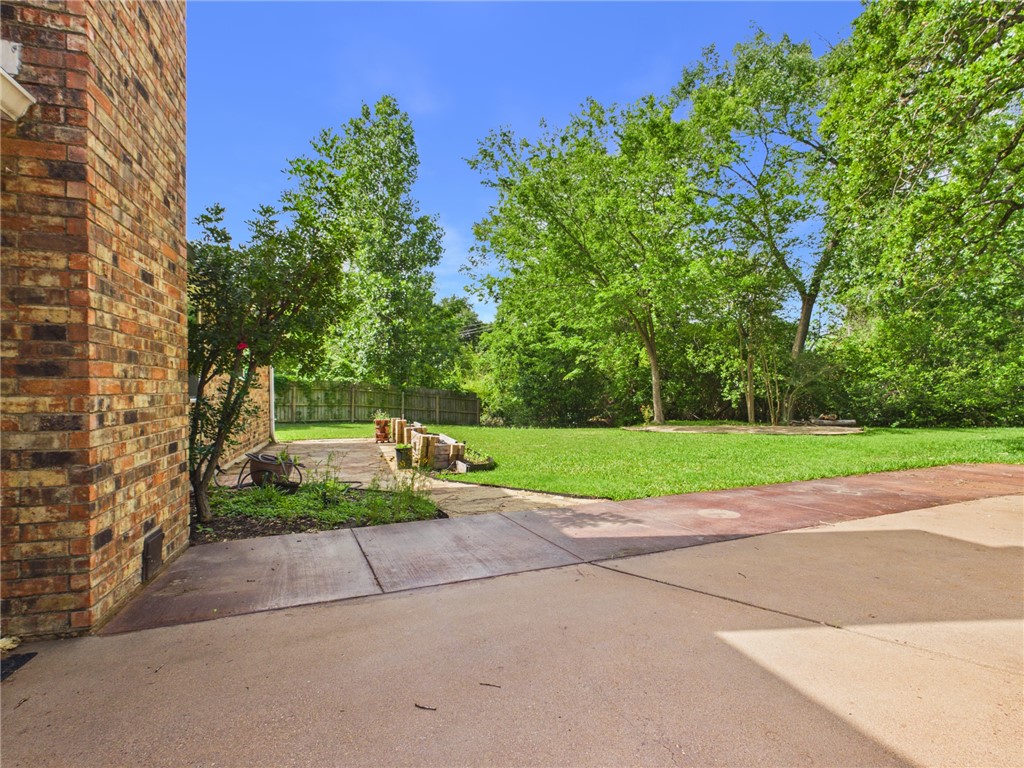 902 Briar Bend Court Bryan, TX 77802 - Photo 33 of 39 a view of backyard with yellow house