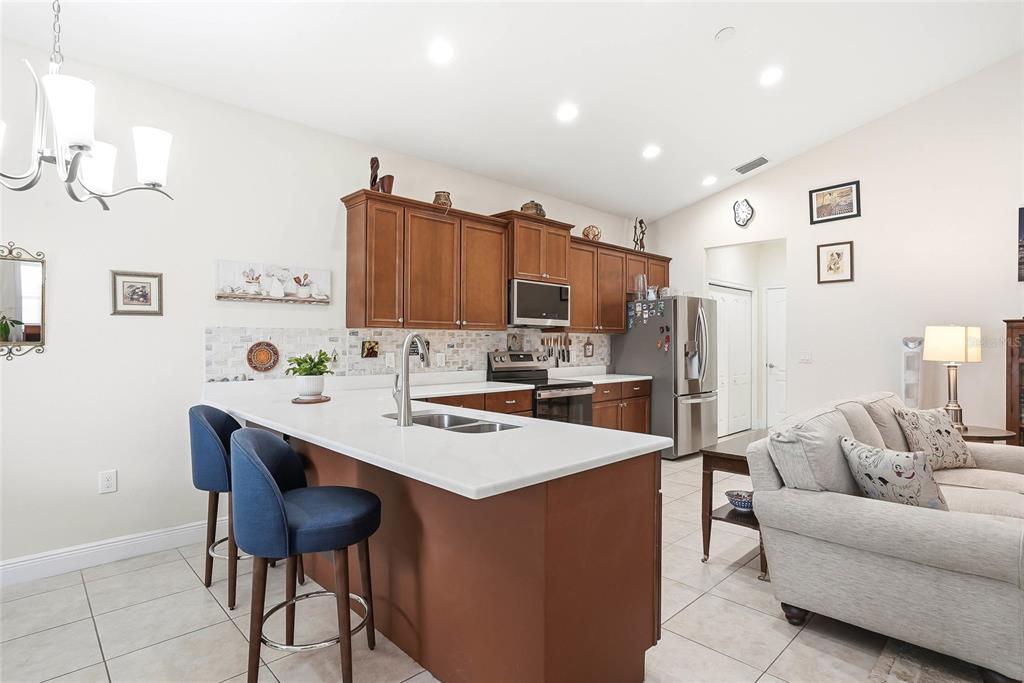 2906 West Douglas Street Tampa, FL 33607 - Photo 11 of 36 a living room with stainless steel appliances kitchen island a table and chairs