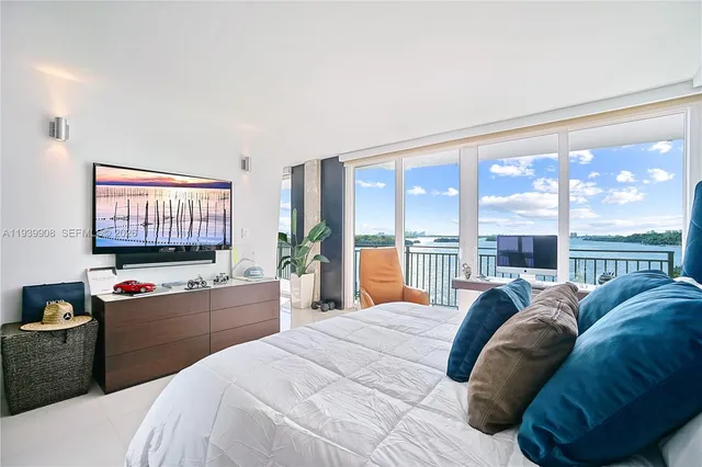 a bedroom with a large bed and a large window